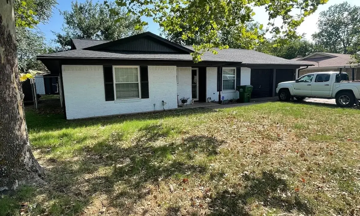 Professional roofing crew working on a residential roof in Ashburnham